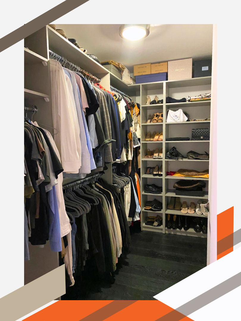A walk-in closet in a modern residential home. The custom storage solution includes an assortment of shelving, short hanging, and long hanging that wrap around the corner of the room in a capital L shape.