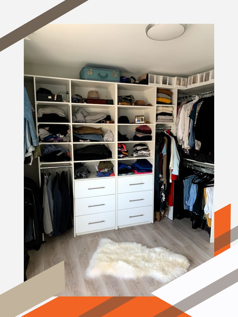 A clean, well-lit walk-in closet in a residential home. The shelves, drawers, and hanging bars are stocked with clothing and shoes to demonstrate how nicely they are now stored.