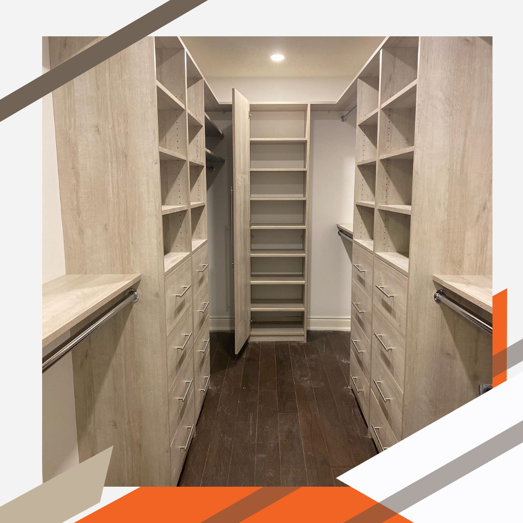 A modern organizational setup in a well-lit walk-in closet completed in a maple finish. The closet is composed of shelving and drawers, short hanging, long hanging, and a shelf that wraps around the top of the shelving for plenty of storage.