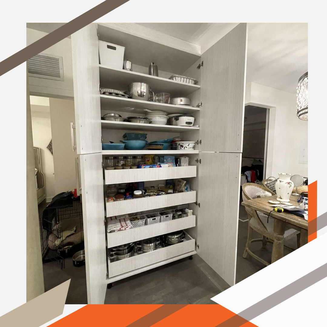 A modern kitchen has been outfitted with a floor-to-ceiling  pantry shelving that includes pull-out drawers.